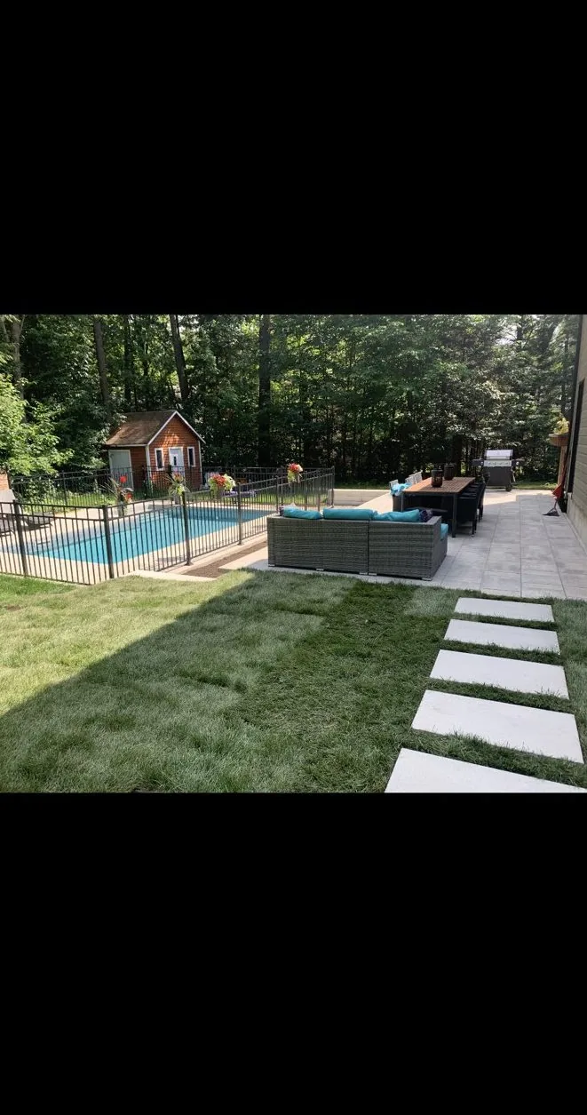 Terrasse en dalles avec pas japonais dans le gazon près d'une piscine